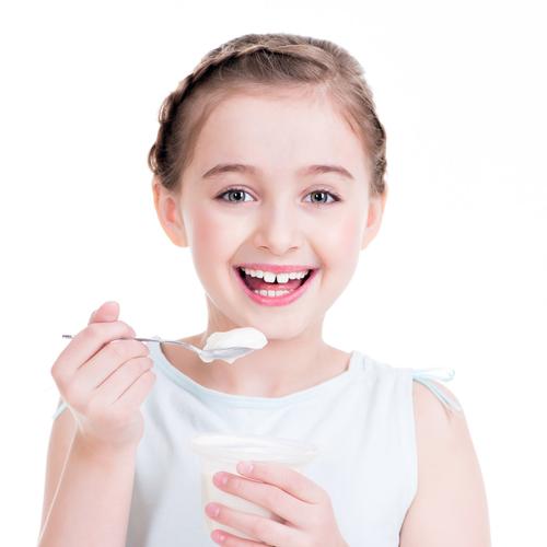 一个小女孩在吃酸奶的肖像.