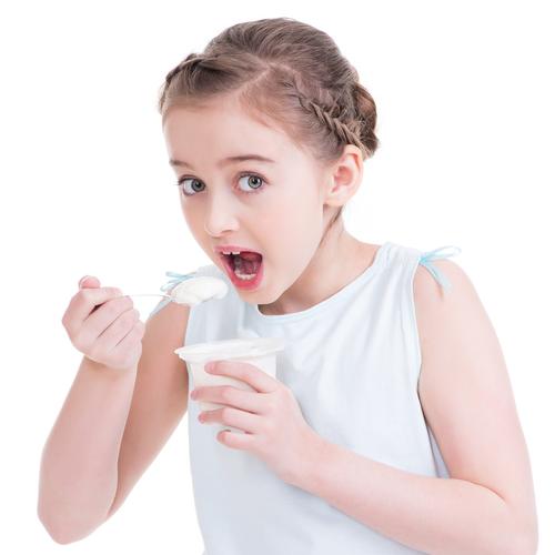 一个小女孩在吃酸奶的肖像.